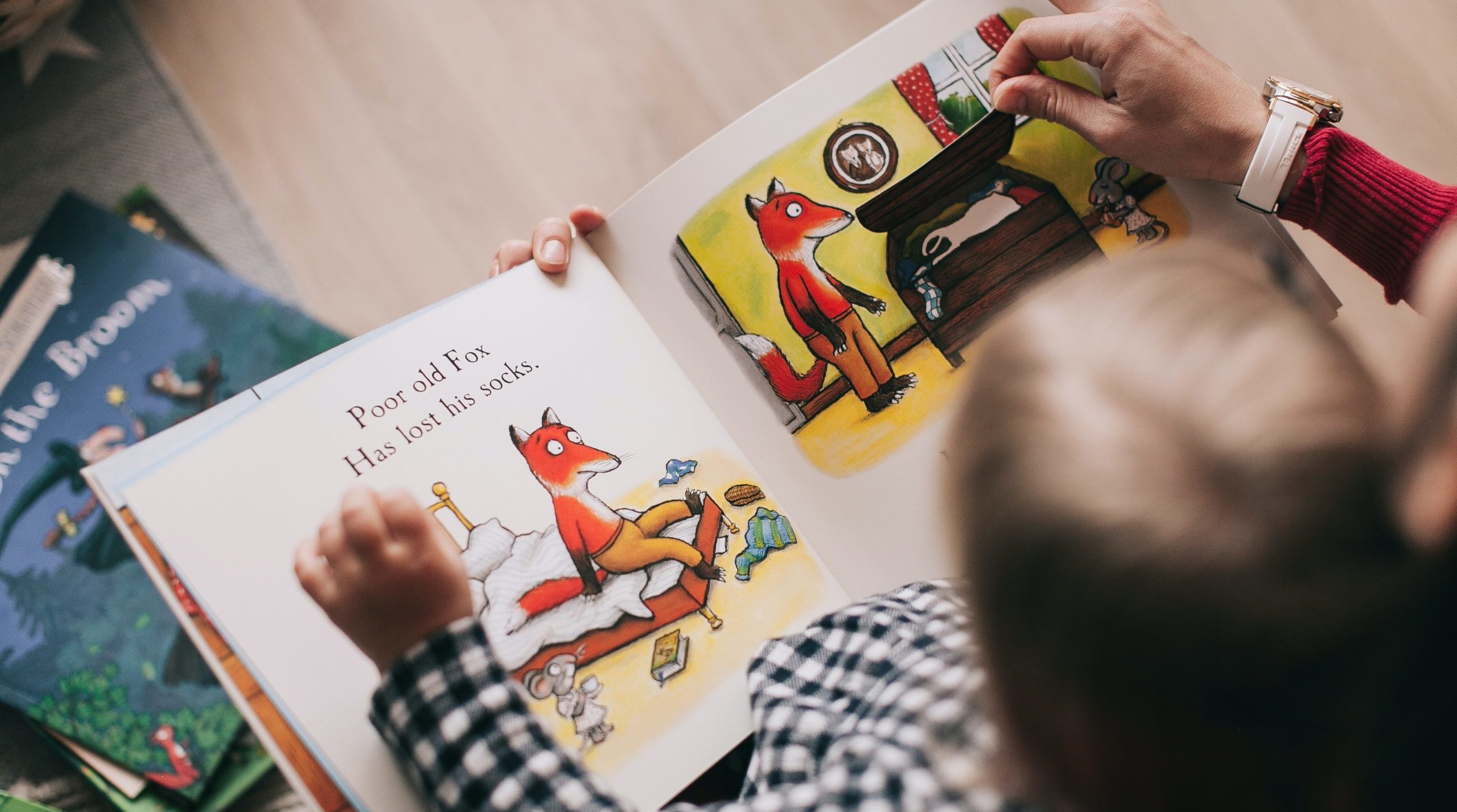 A child reading a poetry book with mother
