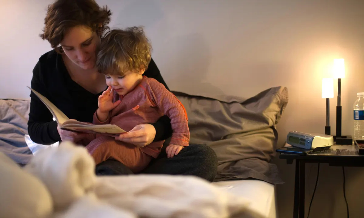 Mom reading before nighttime to kid