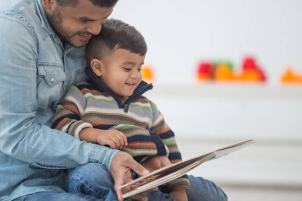 Dad and son reading a book together