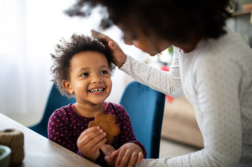 Mom gives a cookie to daughter