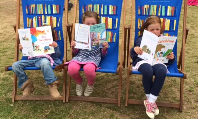 Kids read books together in a book club