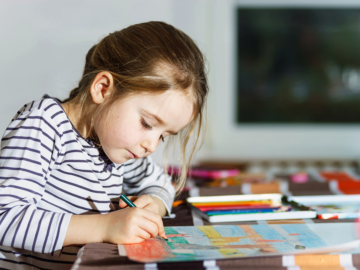 Little girl paints independently