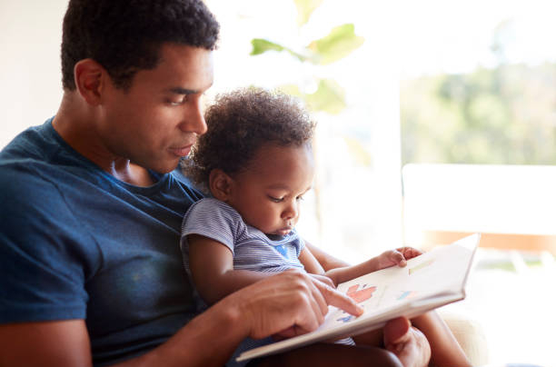 Dad and son reading a book