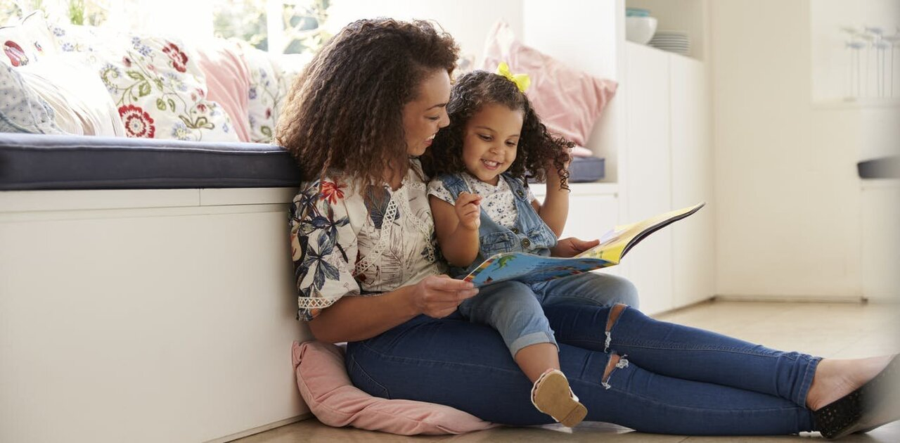 Mom and daughter are reading together