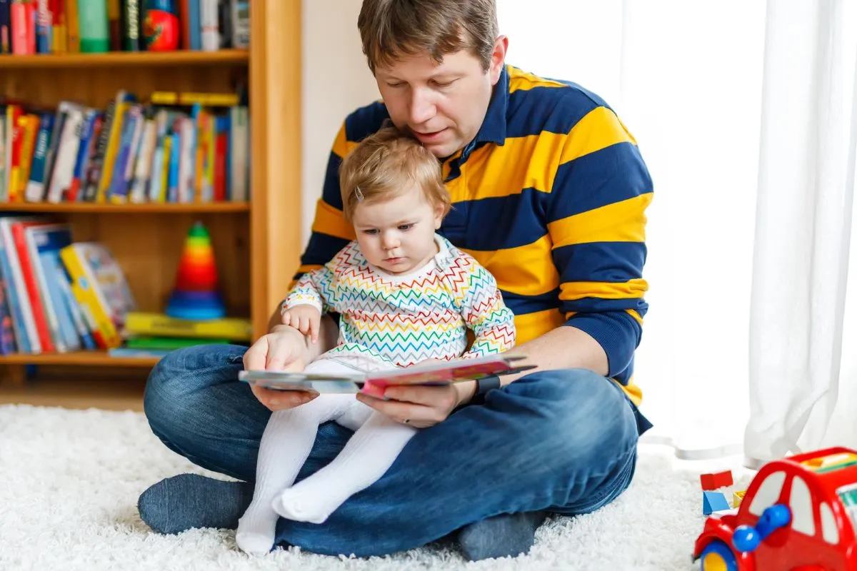 Dad is reading a book with daughter